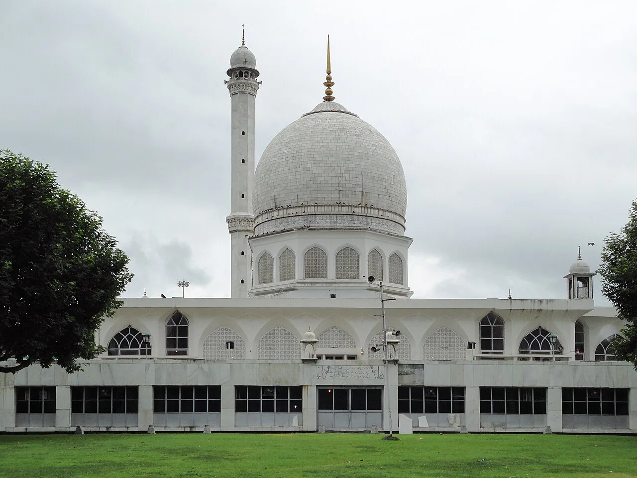 The white marble domed Hazratbal Shrine on the shore of Dal Lake, Srinagar, with its tall minaret and manicured lawn in front