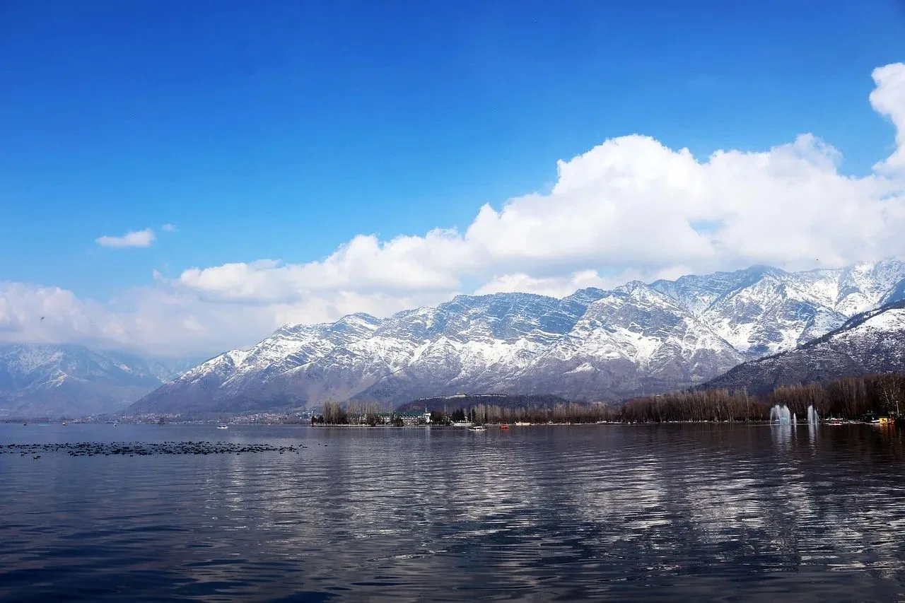 Dal Lake with snow-capped mountains on a clear day, Srinagar