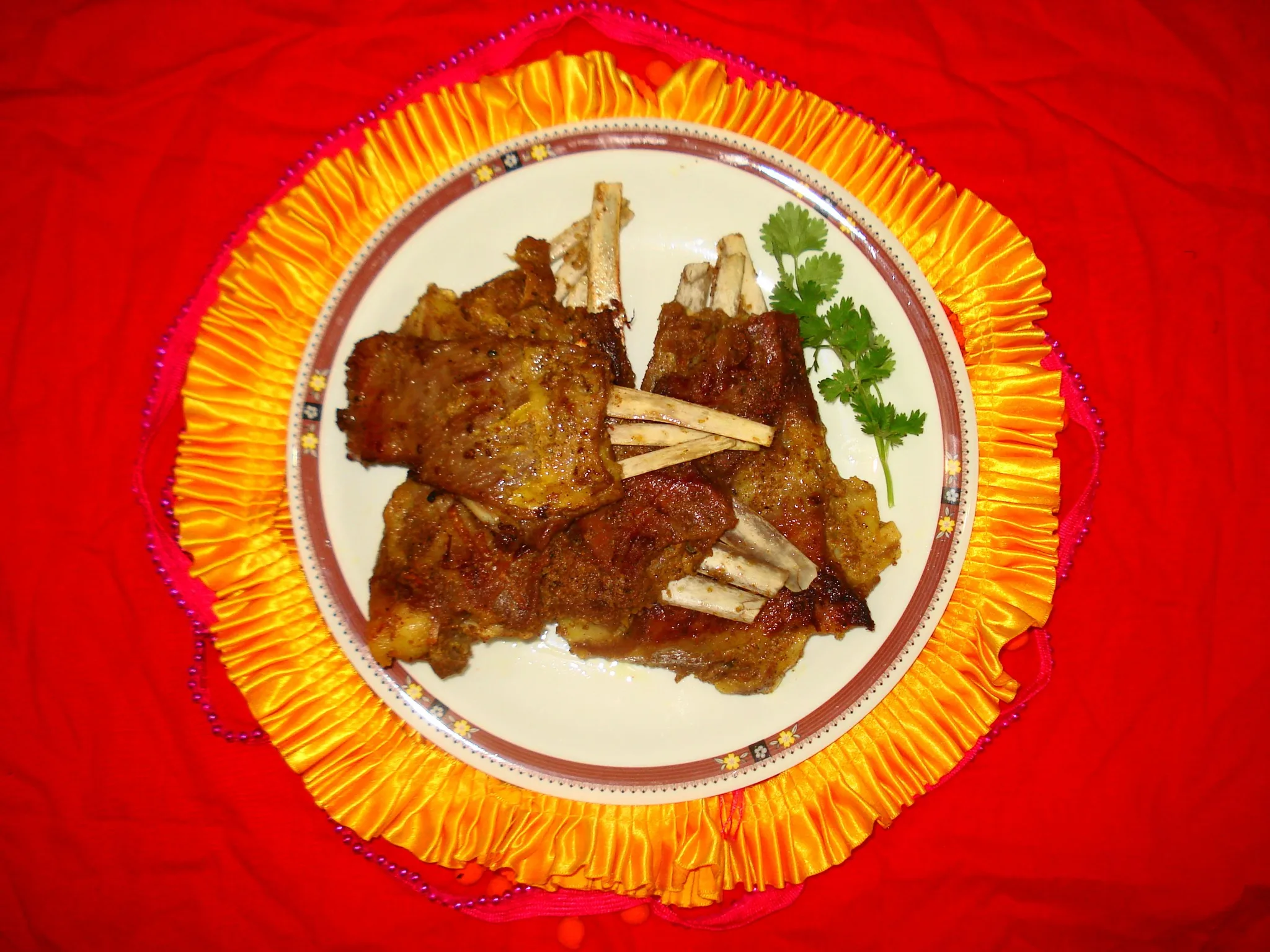 Tabak maaz, crisp fried lamb ribs served in a wazwan