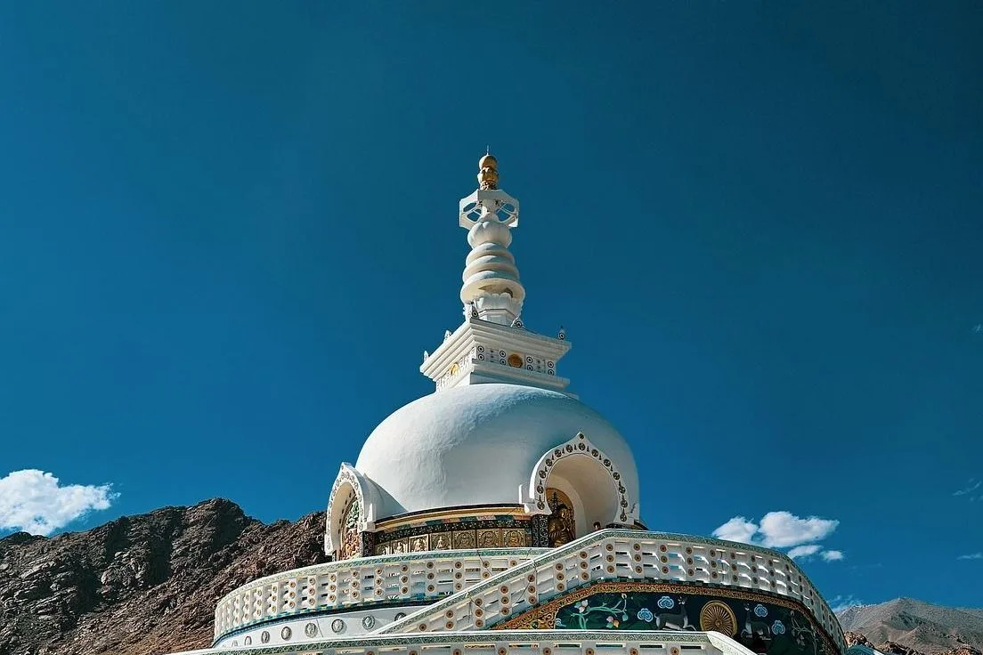 The white dome and terraces of Shanti Stupa in Leh under a deep blue sky